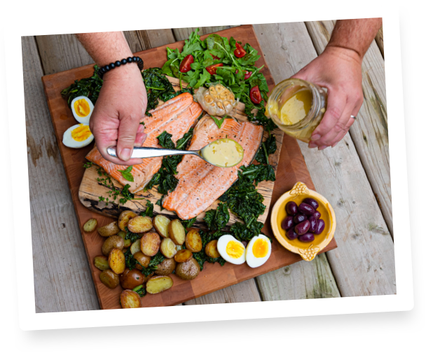 fish on platter being dressed with mustard