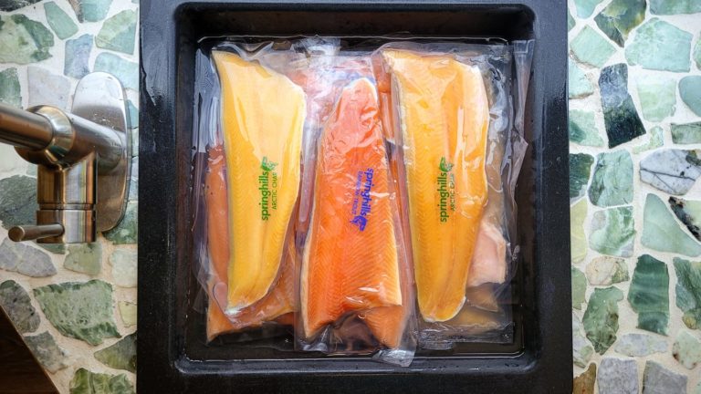 frozen trout and char fillets thawing in sink