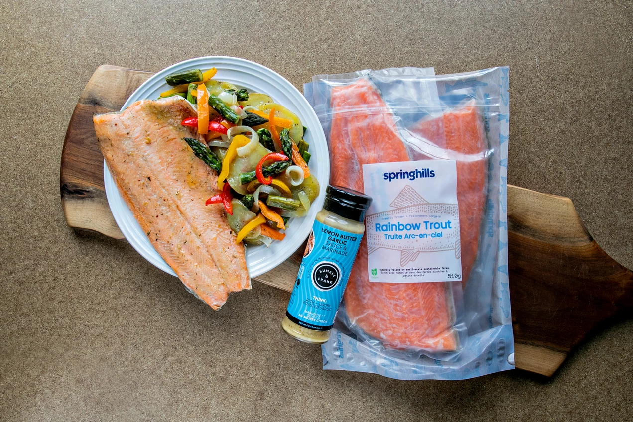 Rainbow trout oven dinner with Humble and Frank sauce on wood board