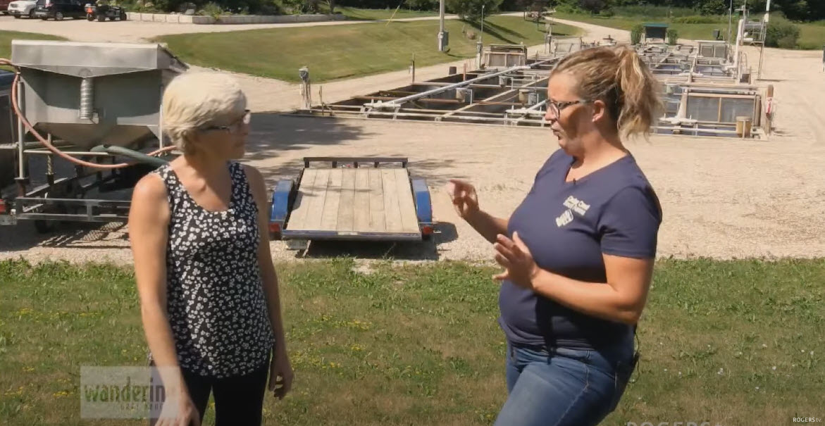 woman fish farmer touring fish farm