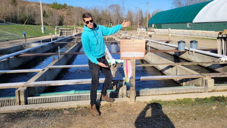 man touring fish farm