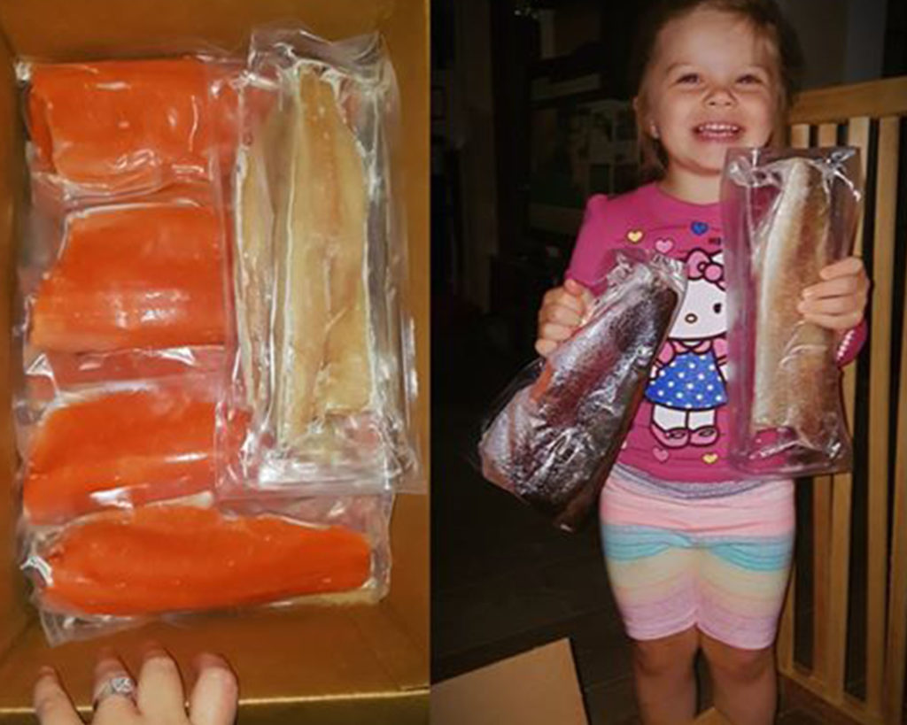 girl holding frozen trout and pickerel fish