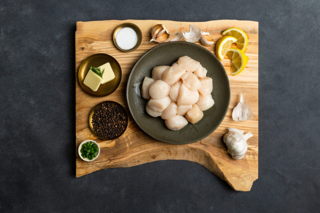 Atlantic scallops on wood board